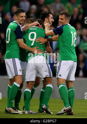 Northern Ireland's Will Grigg (centre) celebrates scoring his side's third goal during the International Friendly at Windsor Park, Belfast. Stock Photo