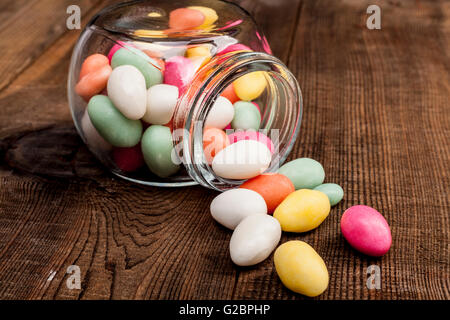 Spilled From Jar Color Candy on Wood Table Stock Photo