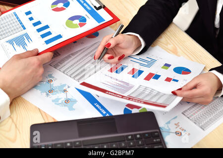 Two employees discussing business chart in office. Close up Stock Photo