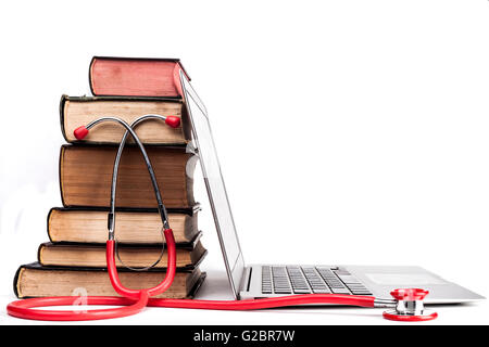 Old Books Pile With Silver Laptop and Stethoscope Isolated on White Background Stock Photo