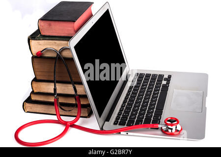 Old Books Pile With Silver Laptop and Stethoscope Isolated on White Background Stock Photo