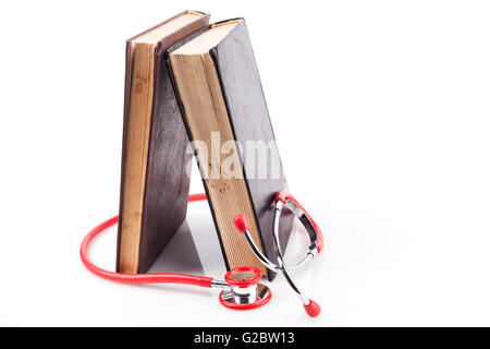 Two Books with Red Stethoscope on White Background With Reflection Stock Photo