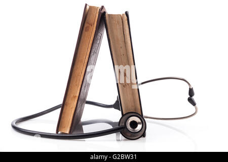 Two Books with black Stethoscope on white background with reflection Stock Photo