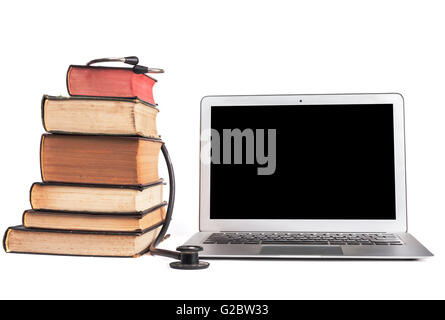 Old Books black stethoscope ans silver laptop isolated on white background Stock Photo