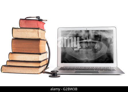 Old Books black stethoscope ans silver laptop isolated on white background Stock Photo