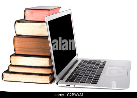 Old Books and silver laptop isolated on white bakground Stock Photo