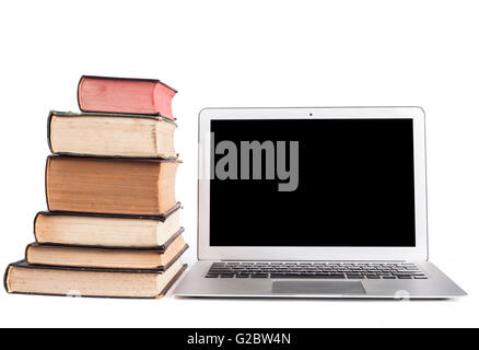 Old Books and silver laptop isolated on white background Stock Photo