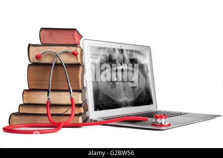 Old Books and xray on silver laptop and red stethoscope isolated on white background Stock Photo