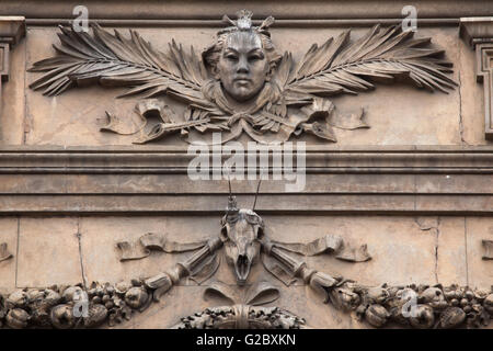 Mascaron flanked with palm leaves and the horned animal skull depicted on east facade of the National Museum on Wenceslas Square Stock Photo