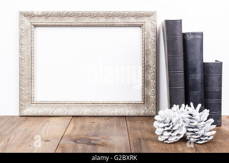 Horizontal Silver Frame With Old Books on Brown Wood Table Stock Photo