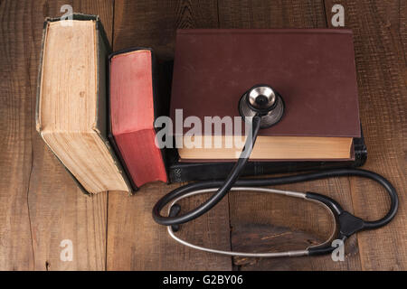 Old Books on Wood Table With Stethoscope Stock Photo