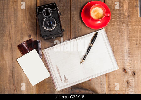Old Camera with Coffee Old Film and Photo on Wood Background Stock Photo