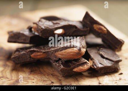 homemade dark chocolate with almond nuts on wooden board Stock Photo