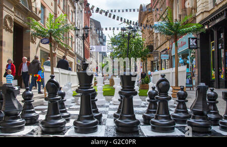 Giant Chess, board, leisure, play, set, chessboard, competition, game, white, big, black, intelligence, piece, queen, strategy, pawn, park, move, knight, king, outdoor, battle, concept, large, objects, figure, group of pieces set on May Spring Bank Holiday in Manchester's central business district. Stock Photo