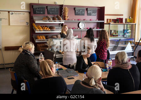 Instruction in the vocational school at the bakery counter in the classroom. Stock Photo