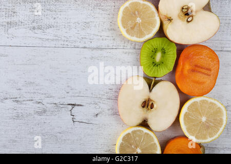 Slices of healthy fruit on white wood. Top view with copoy space Stock Photo