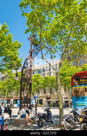 Spain Catalonia Barcelona Eixample Passeig de Gracia ornate Gaudi style combined bench seat & street standard light Stock Photo