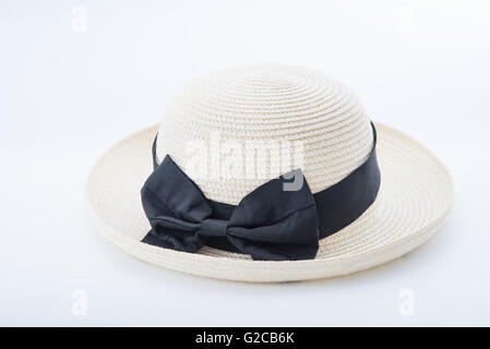 women hat on white background, straw and black ribbon. Stock Photo