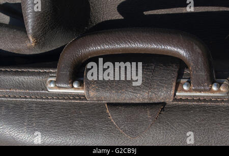 Close up of handle on old worn leather briefcase Stock Photo