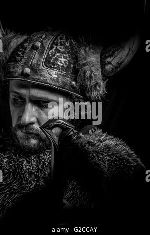 Sign, Costume, Viking warrior with a huge sword and helmet with horns Stock Photo