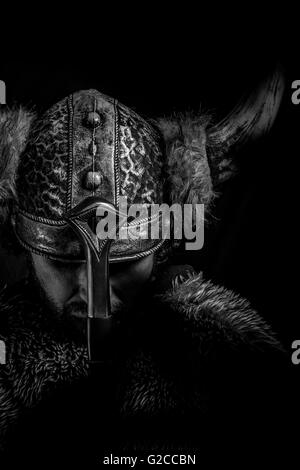 Costume, Viking warrior with a huge sword and helmet with horns Stock Photo