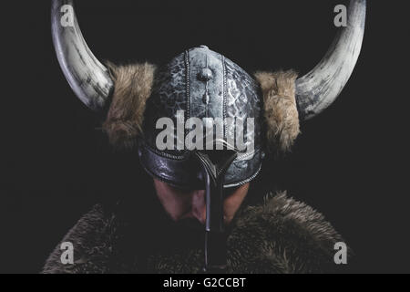 Murderer, Viking warrior with iron sword and helmet with horns Stock Photo