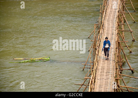 Traveller and Laotian people use bamboo bridge for walk crossing mekong river on April 9, 2016 in Luang Prabang, Laos Stock Photo