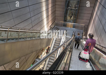 Copenhagen, Denmark - April 25, 2016: People using escalator in metro station Stock Photo