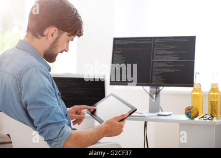 Happy young man using his tablet Stock Photo