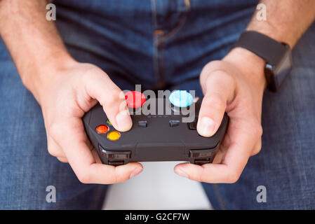 Man holding joystick in both hands Stock Photo
