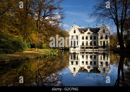 Castle Staverden reflecting in the moat and surrounded by autumn colored trees Stock Photo