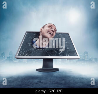 Man looking from cracked monitor Stock Photo