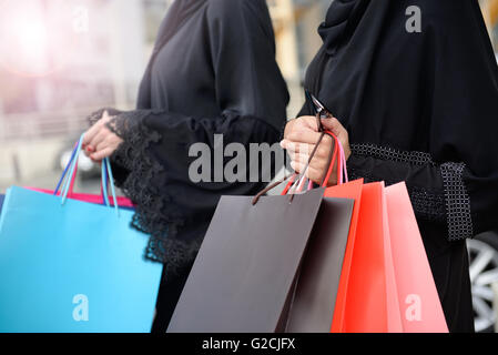 Emarati Arab women coming out of shopping in Dubai, United Arab Emirates. Stock Photo