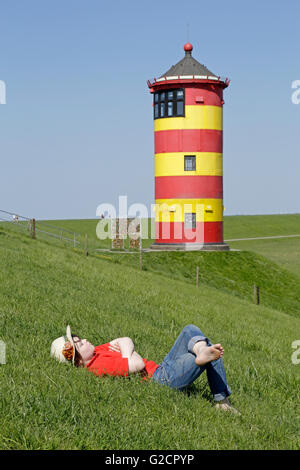 young boy in front of Pilsum Lighthouse, Pilsum, East Friesland, Lower Saxony, Germany Stock Photo