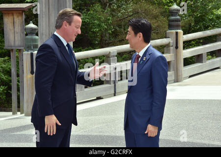 Japanese Prime Minister Shinzo Abe greets British Prime Minister David Cameron during the G7 Summit tour of the Ise Jingu Shrine May 26, 2016 in Ise, Japan. Ise Jingu is the most important shrine for Japan's indigenous Shinto religion. Stock Photo