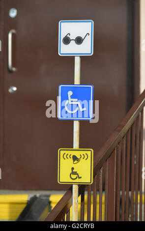 Information signs for people with disabilities near front door Stock Photo