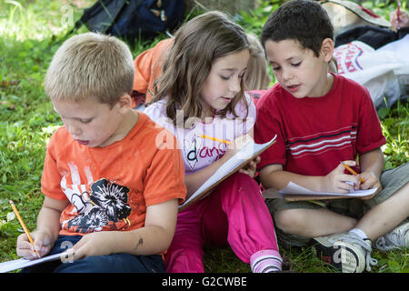 Kids studying together outside Stock Photo