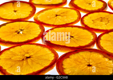 Pattern of group of orange slices against the light. Close up. Elevated view Stock Photo