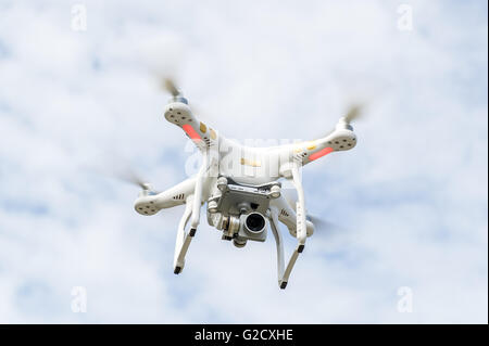DJI Phantom 3 Professional drone with camera hovers in the sky in Ireland. Stock Photo
