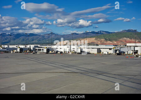 Tarmac and exterior departure and arrival gates at the Salt Lake City International Airport.  Mountains scenery. Stock Photo