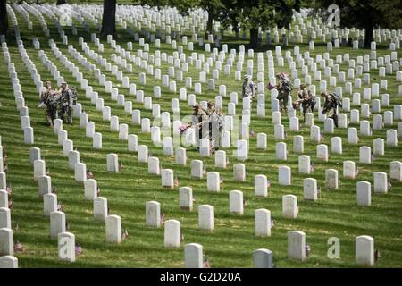Arlington National Cemetery, Virginia, USA. 27th May, 2016. U.S soldiers with The Old Guard place hundreds of American flags at gravesites in Arlington National Cemetery in honor of Memorial Day May 27, 2016 in Arlington, Virginia This tradition, known as 'Flags In,' has been conducted annually since The Old Guard was designated as the Army's official ceremonial unit in 1948. Credit:  Planetpix/Alamy Live News Stock Photo
