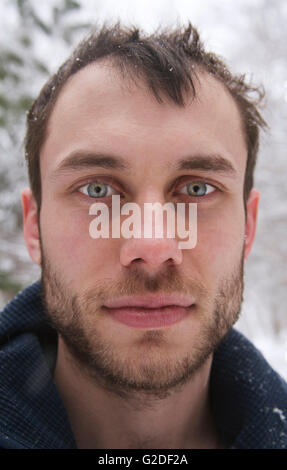 Young Bearded Man with Snowflakes on Head, Close-Up Portrait Stock Photo