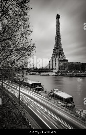 The Eiffel Tower and Seine River in early morning with clouds and car light trails in Black & White. Paris, France Stock Photo