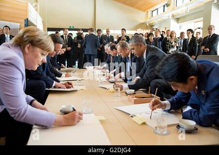 U.S President Barack Obama joins other world leaders in signing the guestbook at the Sanshuden at the Ise-Jingu Shrine during the G7 Summit May 26, 2016 in Ise, Mie Prefecture, Japan. Stock Photo