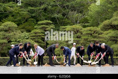 World leaders at the G7 Summit meeting plant trees in honor of their visit to the Ise Jingu Shinto shrine May 26, 2016 in Ise, Japan. Left to Right: Governor of Mie Prefecture Eikei Suzuki, Italian Prime Minister Matteo Renzi, German Chancellor Angela Merkel, U.S. President Barack Obama, Japanese Prime Minister Shinzo Abe, French President Francois Hollande and British Prime Minister David Cameron, Canadian Prime Minister Justin Trudeau, and European Commission President Jean-Claude Juncker. Stock Photo