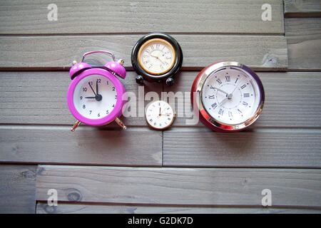 Group of Clocks on wood Stock Photo