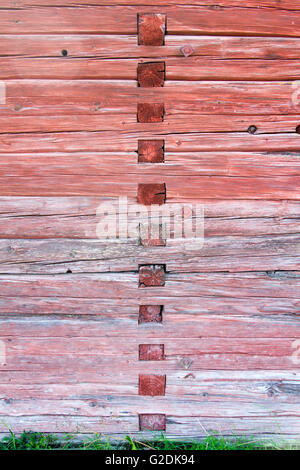 Red barn wall with mortise and tenon joinery creating a pattern Stock Photo