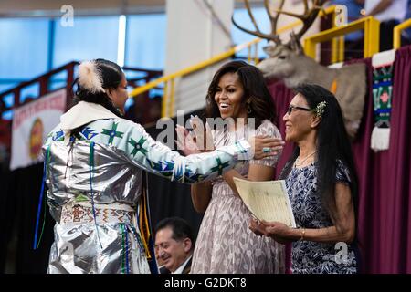 U.S First Lady Michelle Obama with Hannah Lucero, right, applauds Emanuel Vigil after he delivered the Valedictorian address during the Santa Fe Indian School high school commencement ceremony May 26, 2016 in Santa Fe, New Mexico. Stock Photo