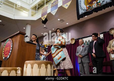 U.S First Lady Michelle Obama shows off a traditional blanket during the Santa Fe Indian School high school commencement ceremony May 26, 2016 in Santa Fe, New Mexico. Stock Photo