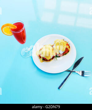 Eggs Benedict with Salmon and Red Mimosa Cocktail, High Angle View Stock Photo